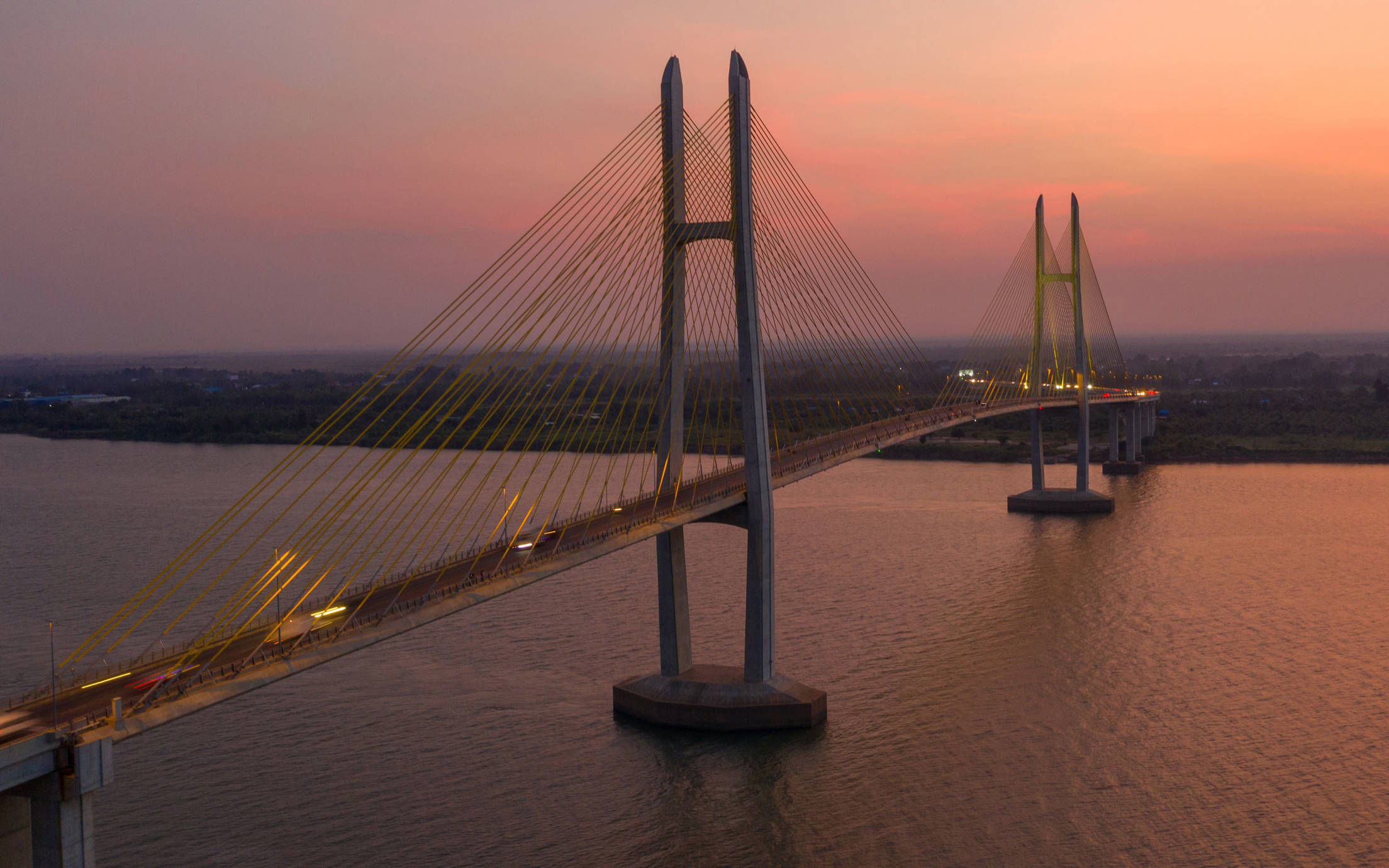 Long suspension bridge below the evening sky