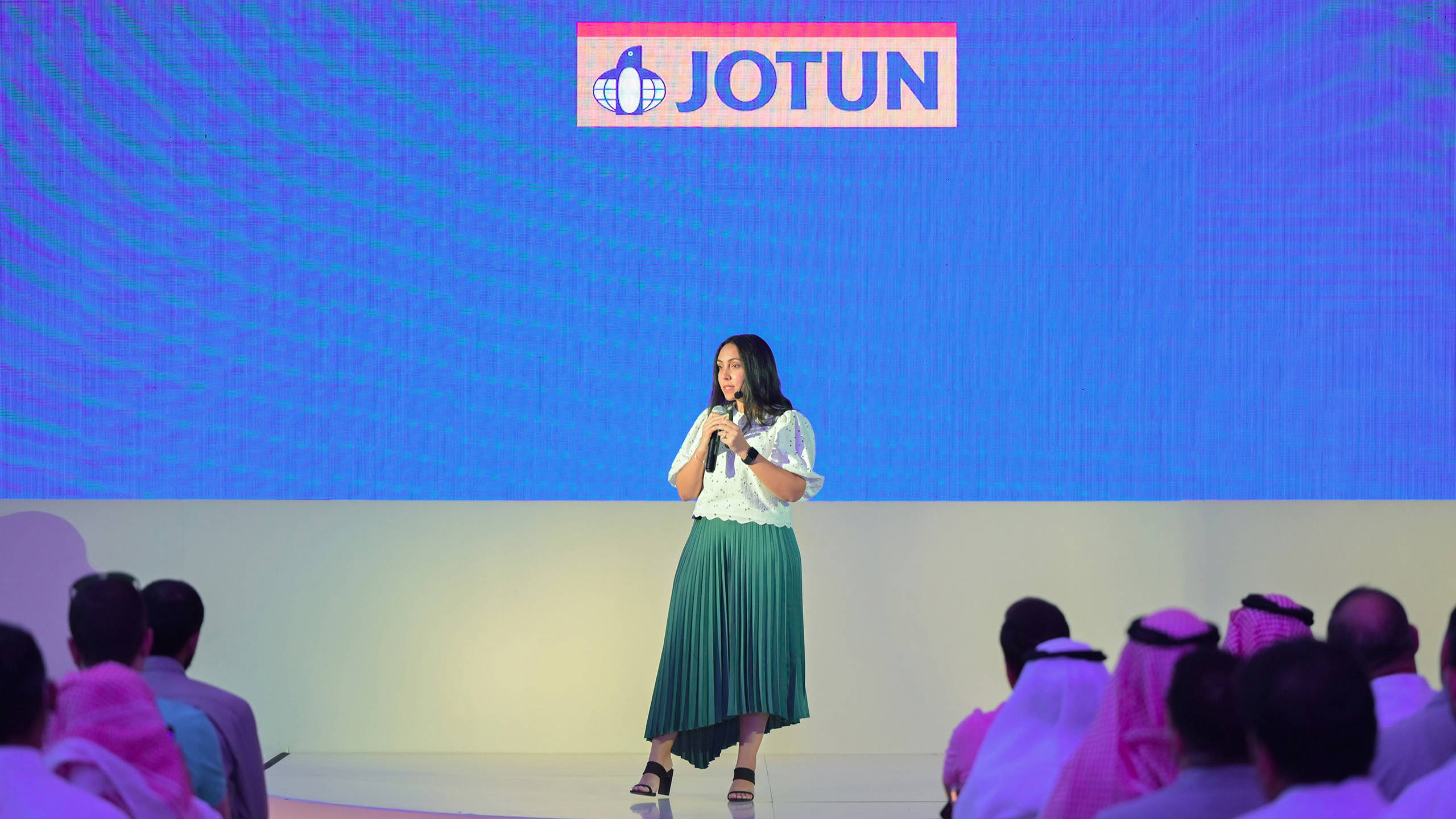 Yasmine Eladly on stage with a microphone