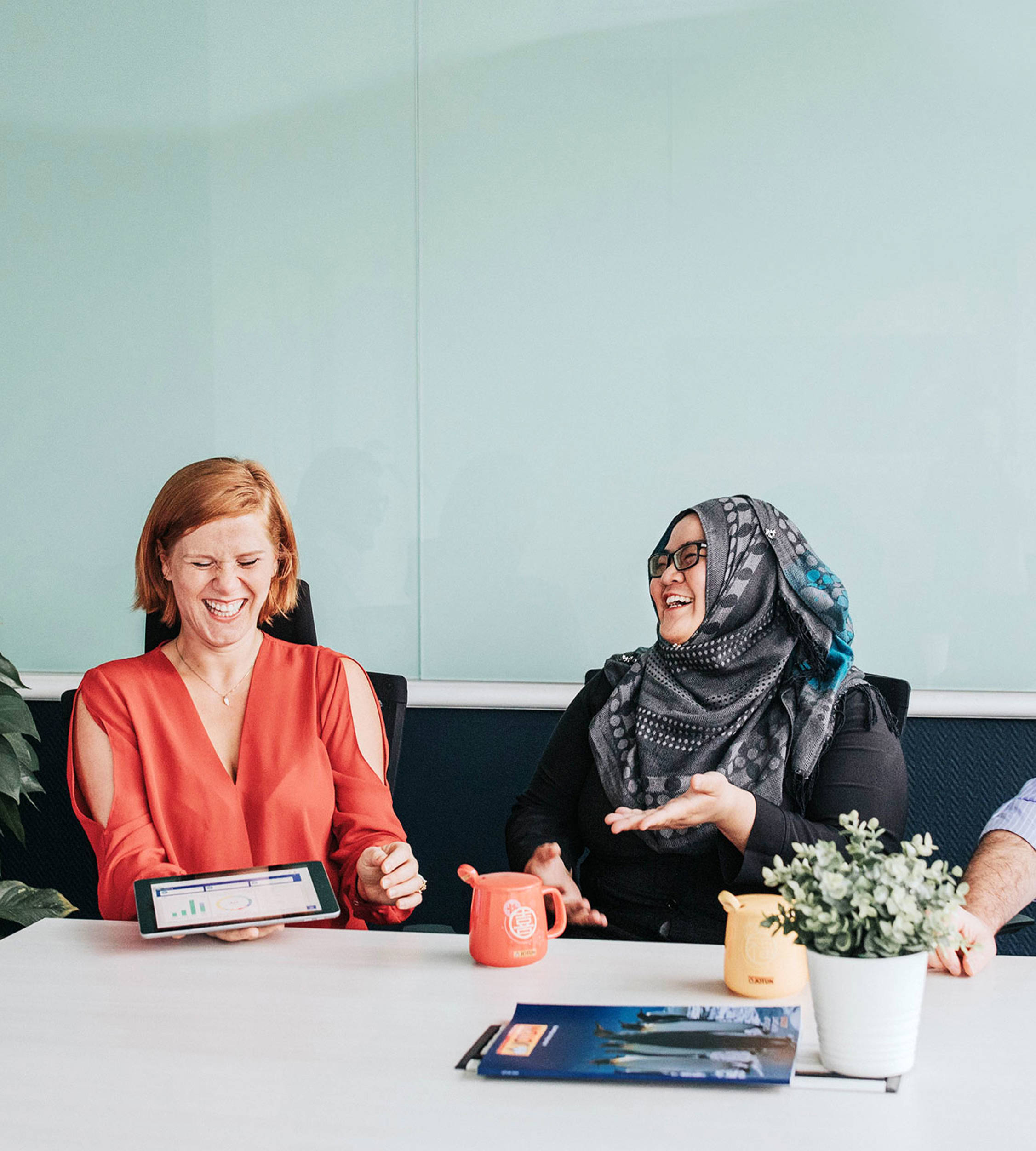 Four people sitting at a table laughing